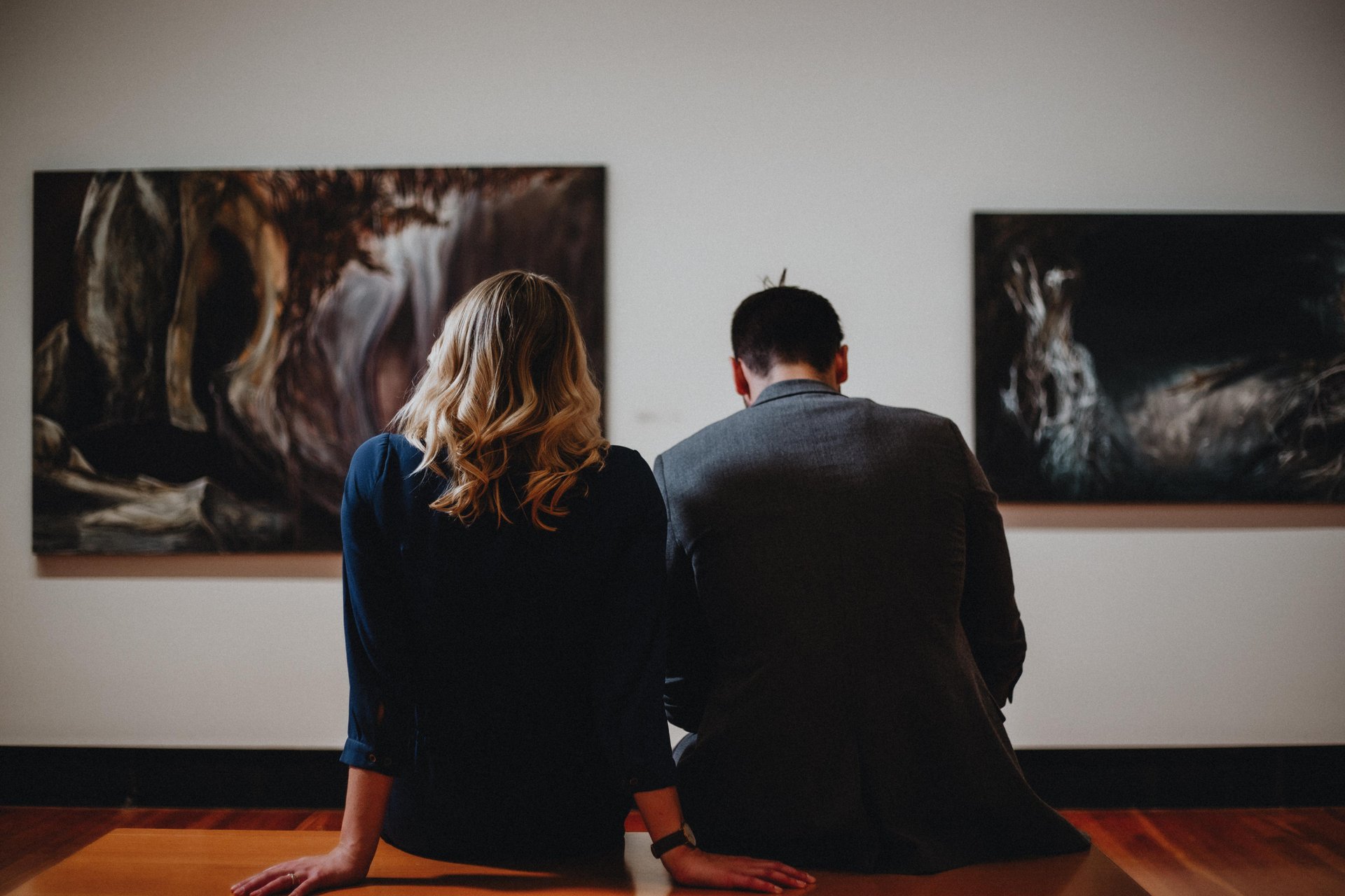 Two people with their backs to the camera, looking at a museum exhibit.